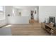 Upstairs hallway featuring hardwood floors leading to an entrance and sitting area with views of the surrounding area at 6099 N Netherland Ct, Aurora, CO 80019
