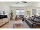 Spacious living area with wood floors, natural light, and modern furniture at 6099 N Netherland Ct, Aurora, CO 80019