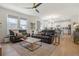 Bright living space connects to the kitchen, featuring hardwood floors and comfortable seating at 6099 N Netherland Ct, Aurora, CO 80019