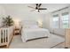 Light and bright main bedroom with white bedding, rug, and neutral decor at 6099 N Netherland Ct, Aurora, CO 80019