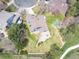 Bird's-eye view showcases a sprawling backyard with stone patio and mature trees at 18 Brixham Ct, Castle Pines, CO 80108