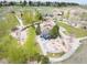 Aerial view showcases a vibrant neighborhood park with playground and recreational areas at 18 Brixham Ct, Castle Pines, CO 80108