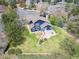 High-angle view of home with manicured backyard, stone patio, and lush landscaping at 18 Brixham Ct, Castle Pines, CO 80108