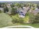 Panoramic aerial view captures the sprawling backyard with stone patio and lush greenery at 18 Brixham Ct, Castle Pines, CO 80108