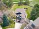 Overhead view of home with brown roof, lush landscaping, and a paved driveway at 18 Brixham Ct, Castle Pines, CO 80108