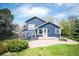 Charming blue two-story home featuring a stone patio and fire pit in the lush backyard at 18 Brixham Ct, Castle Pines, CO 80108