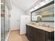 Bathroom featuring double vanity, walk-in shower with glass door and neutral color palette at 18 Brixham Ct, Castle Pines, CO 80108