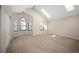 Spacious bedroom with vaulted ceilings, skylights, multiple windows, and neutral carpeting at 18 Brixham Ct, Castle Pines, CO 80108
