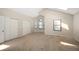 Large bedroom with vaulted ceiling, dormer window and closet with neutral colored carpet at 18 Brixham Ct, Castle Pines, CO 80108