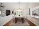 Open dining area with view of living room, lots of light, modern chandelier, table and chairs at 18 Brixham Ct, Castle Pines, CO 80108