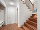 Entryway with tiled floor, stairs with wood treads, and white trim at 18 Brixham Ct, Castle Pines, CO 80108