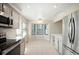 Bright eat-in kitchen with stainless steel appliances, white cabinets, and bay window seating at 18 Brixham Ct, Castle Pines, CO 80108