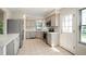 Well-lit kitchen with stainless steel appliances, neutral cabinetry, white counters, and a door to the outside at 18 Brixham Ct, Castle Pines, CO 80108
