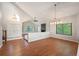 Spacious living room boasts hardwood floors, a vaulted ceiling, natural light and an open layout at 18 Brixham Ct, Castle Pines, CO 80108