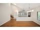 Sunlit living area with hardwood flooring, skylight, and open floor plan at 18 Brixham Ct, Castle Pines, CO 80108
