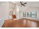 Open living room with hardwood floors, a skylight, and a staircase leading to the upper level at 18 Brixham Ct, Castle Pines, CO 80108