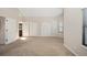 Neutral main bedroom with vaulted ceiling, large windows, and adjacent bathroom at 18 Brixham Ct, Castle Pines, CO 80108