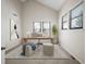 Home office with vaulted ceilings, bright windows, neutral walls and modern decor at 18 Brixham Ct, Castle Pines, CO 80108