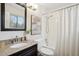 Bathroom with granite vanity, decorative mirror, updated fixtures, and shower-tub combo at 1470 S Quebec Way # 178, Denver, CO 80231