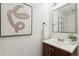 The powder bathroom features modern artwork and an undermount sink at 1470 S Quebec Way # 178, Denver, CO 80231