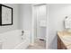 The bathroom includes a combined bathtub and shower and a large, framed vanity mirror at 1470 S Quebec Way # 178, Denver, CO 80231