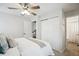 Bright bedroom featuring a ceiling fan, closet, and ensuite bathroom at 1470 S Quebec Way # 178, Denver, CO 80231