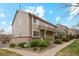 Inviting townhouse exterior with a brick foundation, manicured landscaping, and a cozy front entryway at 1470 S Quebec Way # 178, Denver, CO 80231