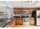 Well-equipped kitchen with stainless steel appliances, granite countertops, and ample cabinet space at 1470 S Quebec Way # 178, Denver, CO 80231