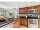 Stylish kitchen with stainless steel appliances, granite countertops, and modern fixtures at 1470 S Quebec Way # 178, Denver, CO 80231