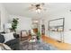 Open-concept living area with hardwood floors, comfortable seating, and seamless flow into the kitchen at 1470 S Quebec Way # 178, Denver, CO 80231