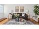 Elegant living room with contemporary artwork, plush seating, and a stylish glass coffee table at 1470 S Quebec Way # 178, Denver, CO 80231