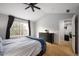Spacious bedroom with carpeted floor, ceiling fan, and access to office at 12826 W Brittany Dr, Littleton, CO 80127