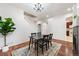 Bright dining room with hardwood floors, chandelier and staircase at 12826 W Brittany Dr, Littleton, CO 80127