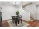 Formal dining space bathed in natural light, featuring hardwood floors, and staircase at 12826 W Brittany Dr, Littleton, CO 80127