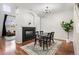 Dining area with hardwood floors and chandelier, adjacent to kitchen at 12826 W Brittany Dr, Littleton, CO 80127