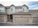 Two-story townhome with attached garage and neutral color scheme at 12826 W Brittany Dr, Littleton, CO 80127