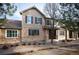 Charming two-story townhome featuring stone accents, neutral siding, and an inviting covered front porch entrance at 12826 W Brittany Dr, Littleton, CO 80127
