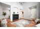 Open living room with hardwood floors, fireplace and high ceilings at 12826 W Brittany Dr, Littleton, CO 80127