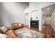 Spacious living room with a fireplace, hardwood floors, and an open layout for versatile living at 12826 W Brittany Dr, Littleton, CO 80127