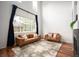 Bright living room with soaring ceilings, expansive windows, and cozy seating arrangement at 12826 W Brittany Dr, Littleton, CO 80127