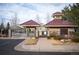Community pool with covered seating and gated entrance at 12826 W Brittany Dr, Littleton, CO 80127