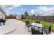 Spacious backyard features a patio with outdoor seating, grassy area, storage shed and wood fence at 687 Prairie Ave, Brighton, CO 80603