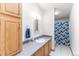 Well-lit bathroom with a vanity, toilet, shower, and a stylish blue and white shower curtain at 687 Prairie Ave, Brighton, CO 80603