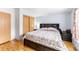 Cozy bedroom features a floral comforter, wood floors, and a closet, creating a warm and inviting space at 687 Prairie Ave, Brighton, CO 80603