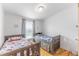 Well-lit bedroom showcasing two beds, a window providing natural light, and simple, clean decor at 687 Prairie Ave, Brighton, CO 80603