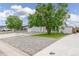 View of the home's front yard, ample parking, and welcoming facade at 687 Prairie Ave, Brighton, CO 80603