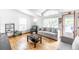 Cozy living room with hardwood floors and natural light coming through large windows at 687 Prairie Ave, Brighton, CO 80603