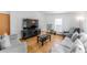 Inviting living room featuring hardwood floors, neutral decor, and comfortable seating at 687 Prairie Ave, Brighton, CO 80603