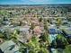 An aerial view of the neighborhood, featuring mature trees, houses, a pool and trampoline at 13183 Spica Dr, Lone Tree, CO 80124