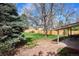 Spacious backyard with a patio, lush green lawn, and mature trees at 13183 Spica Dr, Lone Tree, CO 80124